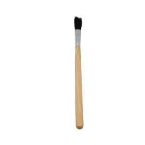 a wooden handled flux brush presented on a white background